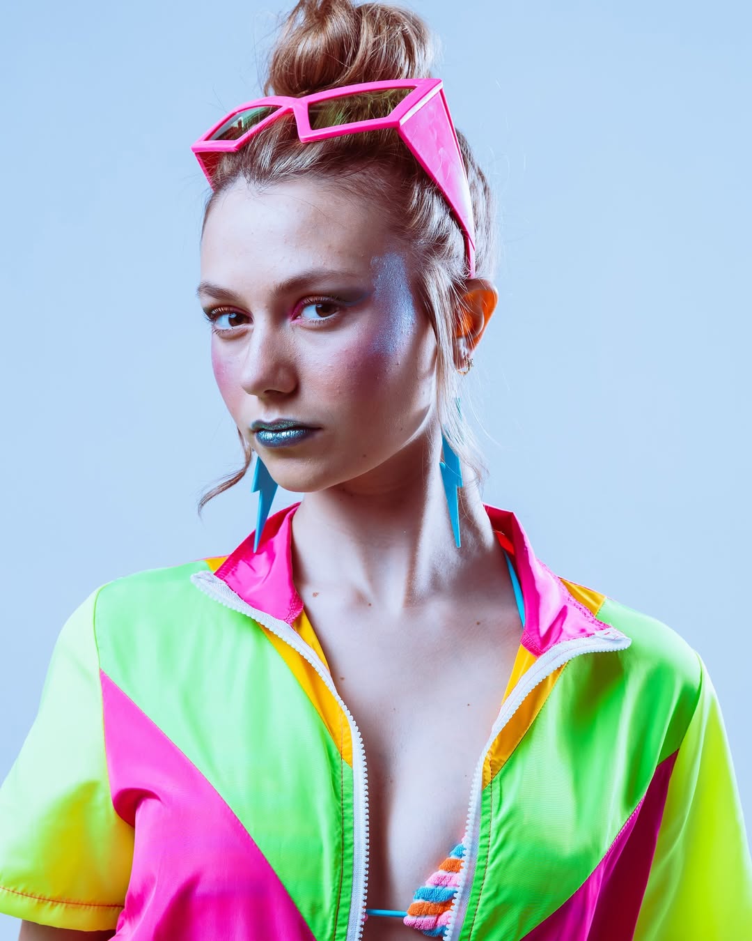 Modeling neon-themed studio look with bold expression and vibrant colors