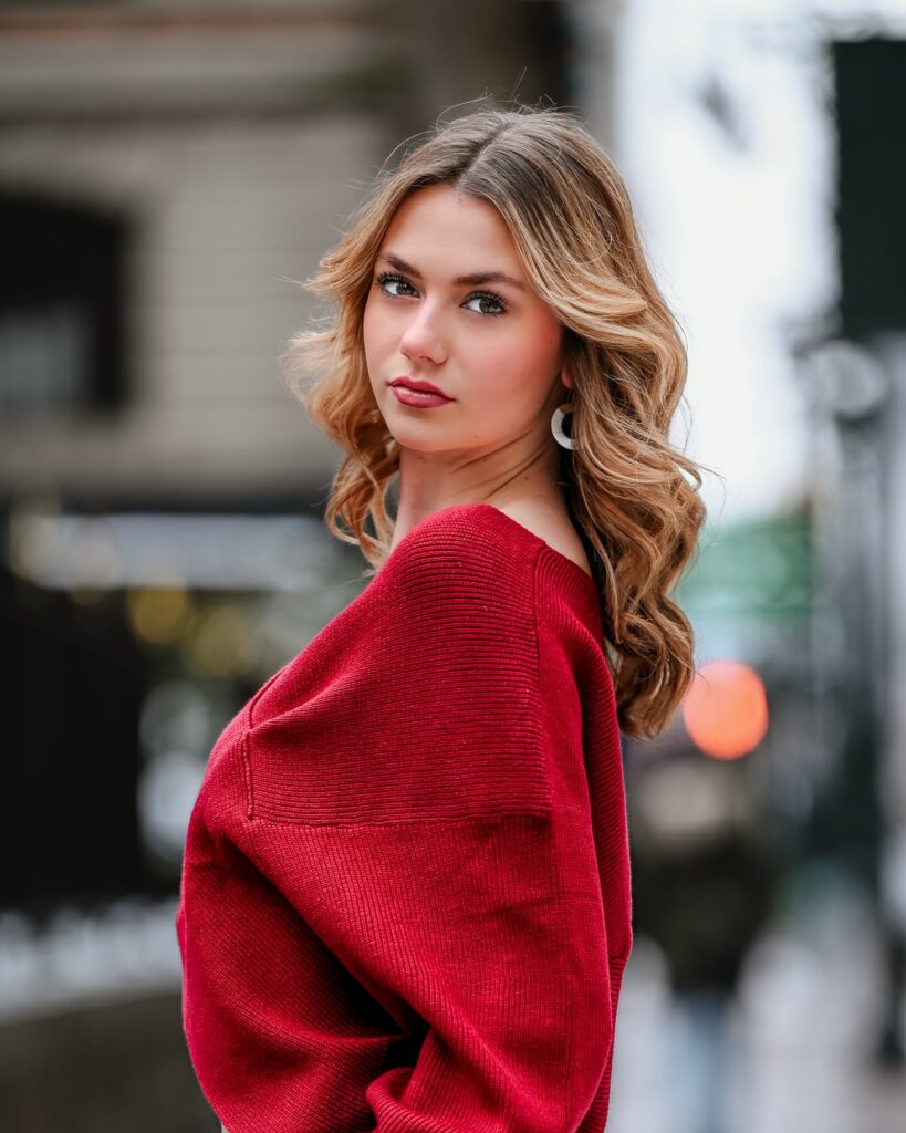 Walking in a city setting in red and denim street-style wardrobe